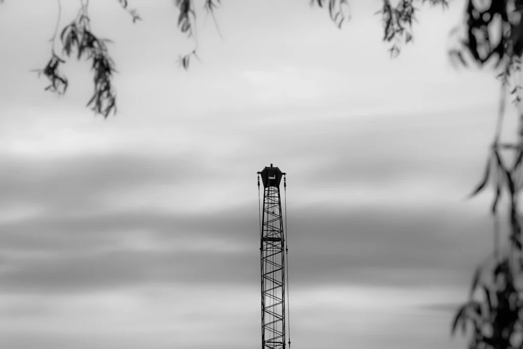 Black and white landscape photograph featuring a tower against a cloudy sky in Vancouver.