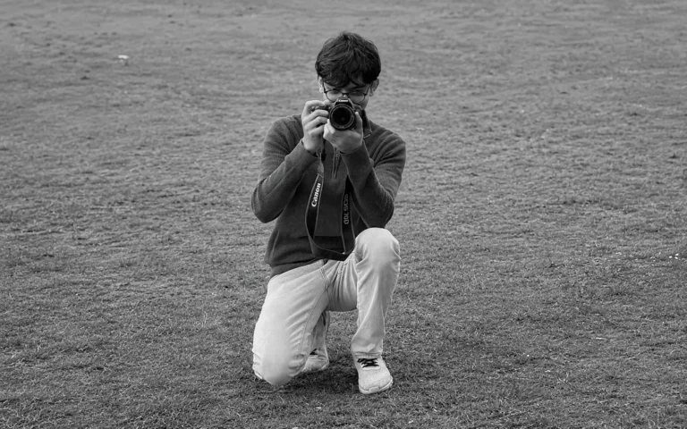 Portrait of Vancouver photographer Prabesh Karki holding a Sony camera during a photoshoot.