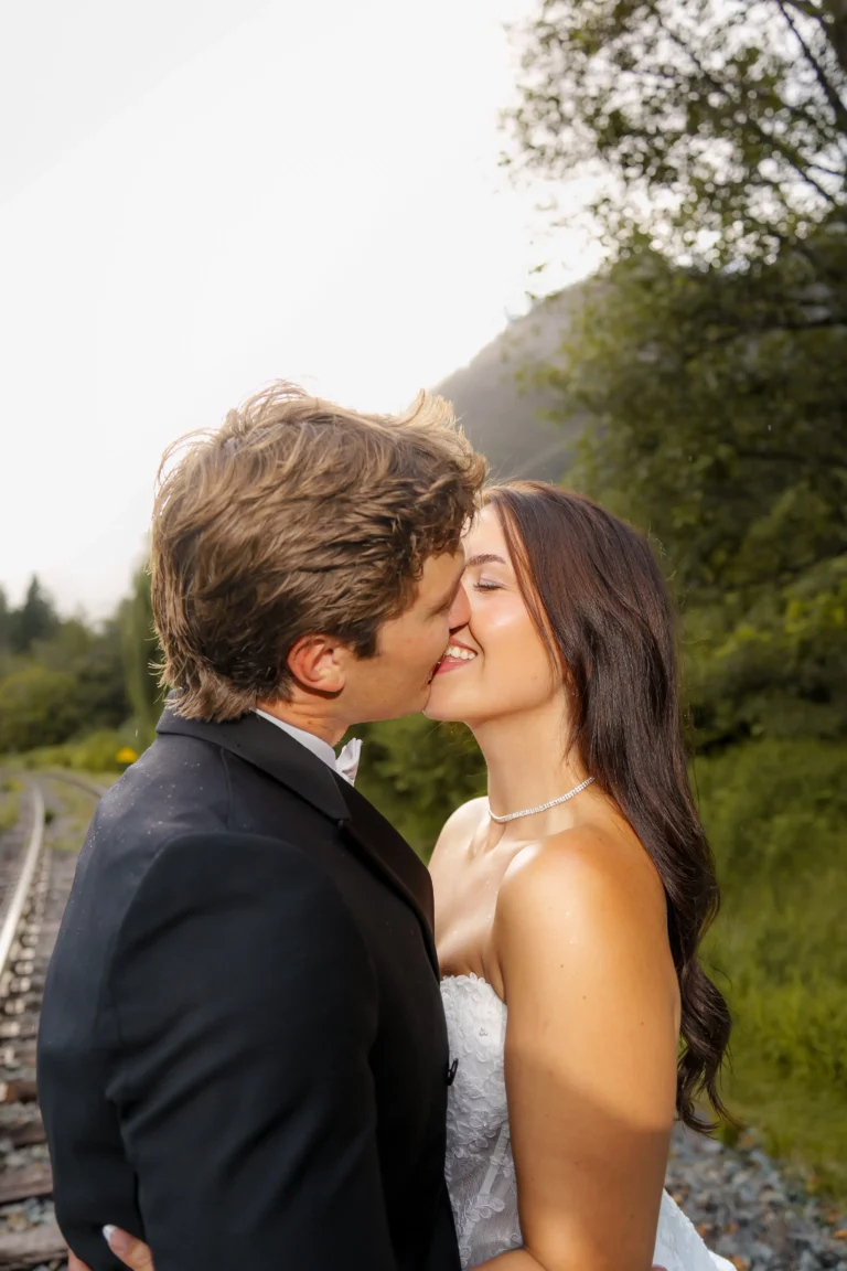Bride and groom sharing a kiss during their outdoor wedding